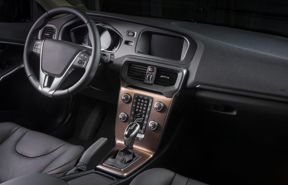 Detailed car interior with clean leather seats, dashboard and centre console